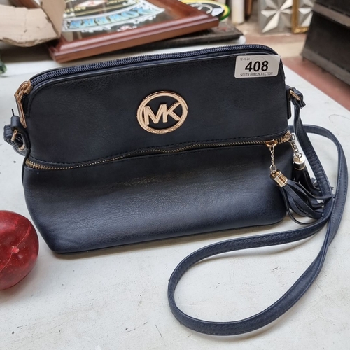 408 - Black Michael Kors crossbody bag with gold-tone hardware and logo. Features top zipper closure and a... 