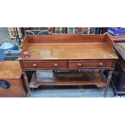 412 - Star Lot : A lovely Victorian mahogany writing desk with raised back, featuring two drawers and turn... 