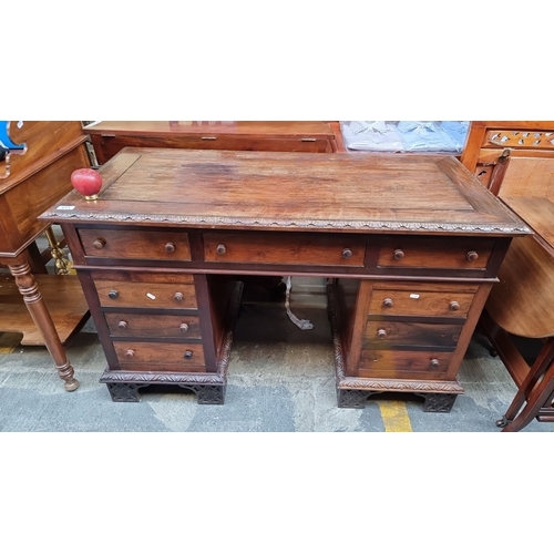 413 - Super star Lot : A stunning Victorian mahogany pedestal desk features intricate carved details, nine... 