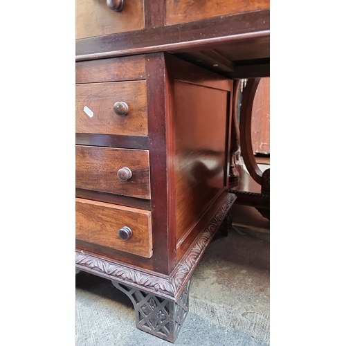 413 - Super star Lot : A stunning Victorian mahogany pedestal desk features intricate carved details, nine... 