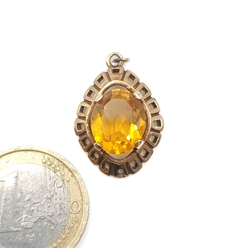 12 - An attractive vintage nine carat gold pendant set with a facet cut citrine stone. Stamped 375. Total... 