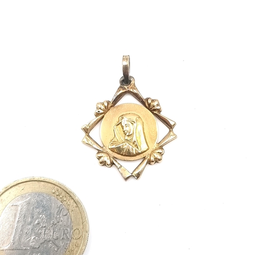 15 - A gold pendant featuring Mother Mary marked 750. Weight - 2.26 grams.