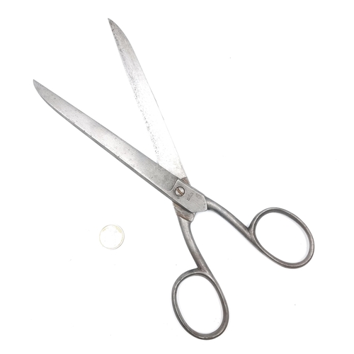 24 - A pair of long haberdashers scissors marked 'Made in Sheffield'. Length - 30 cms. Weight - 224 grams... 