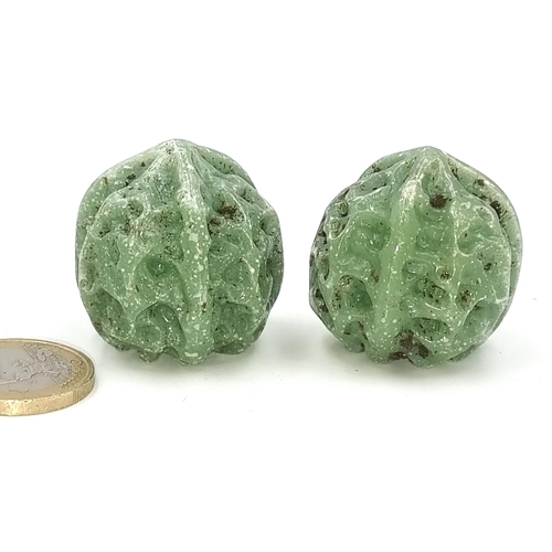 34 - Two nicely carved Jade items in the styles of a walnut. Total weight - 58.5 grams.