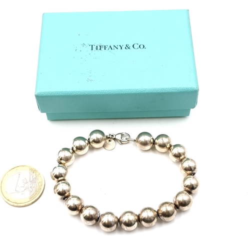 56 - A silver ball bracelet with 'Tiffany & Co.' marked clasp. Weight - 18.75 grams. Comes in Tiffany box... 