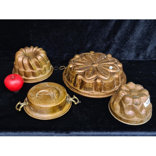 129 - Four antique 19th century copper jelly moulds of various shapes and sizes.