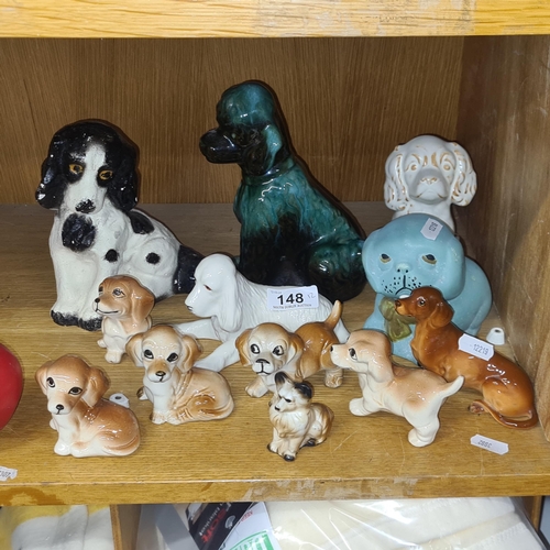 148 - An adorable large selection of 12 ceramic dog figures. Including A Blue Mountain Pottery example.