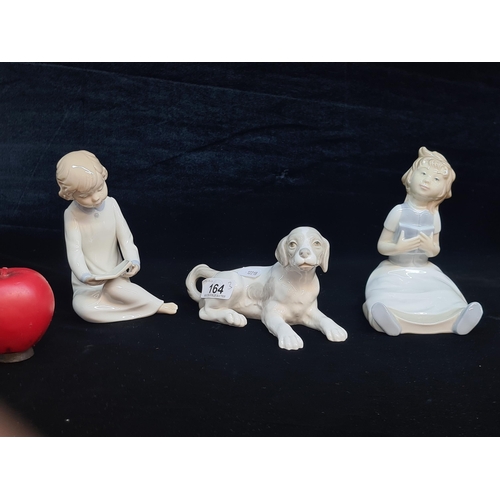 164 - Three pretty pieces of Spanish mad Nao porcelain including a figure of a dog and two young children.