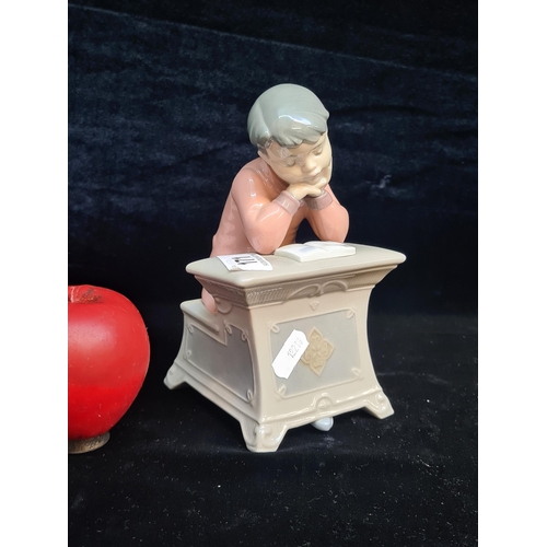 171 - A charming piece of Spanish made Nao porcelain depicting a young child reading at a desk in good ord... 