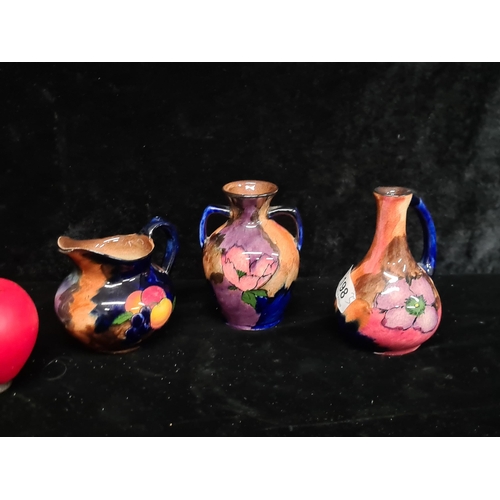 198 - Three H & K Tunstall Violaware pieces including two bud vases and a milk jug. All in the same, very ... 