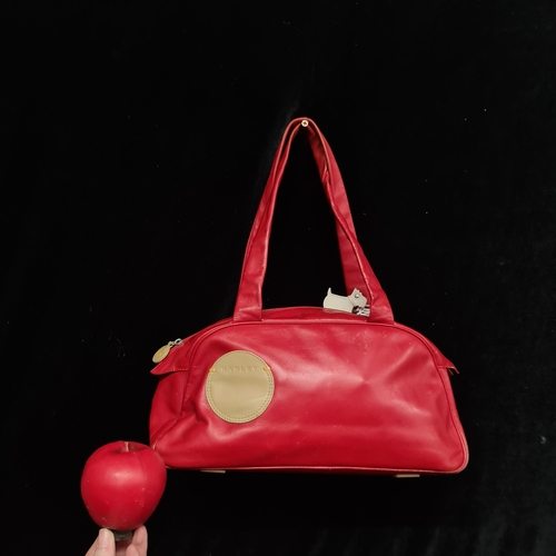 214 - A fashionable Radley bright red leather hand bag. With the scottie doggie.