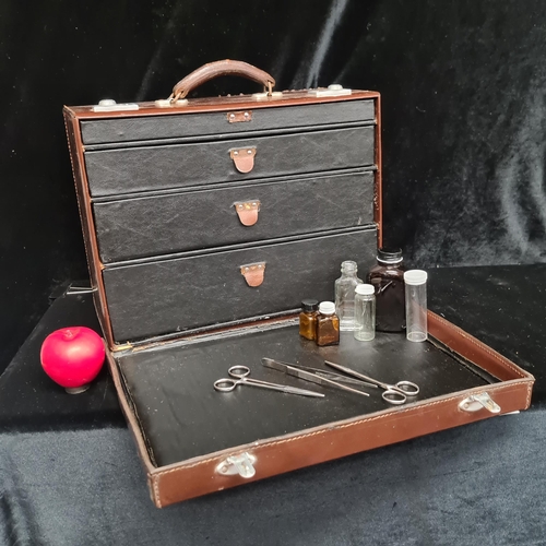 224 - A vintage leather travel doctor's medical box with four graduated drawers to interior with some vint... 