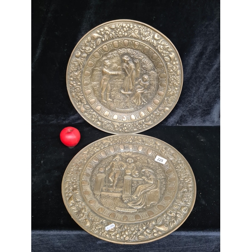 225 - Two antique brass chargers depicting traditional British scenery in high relief one titled 