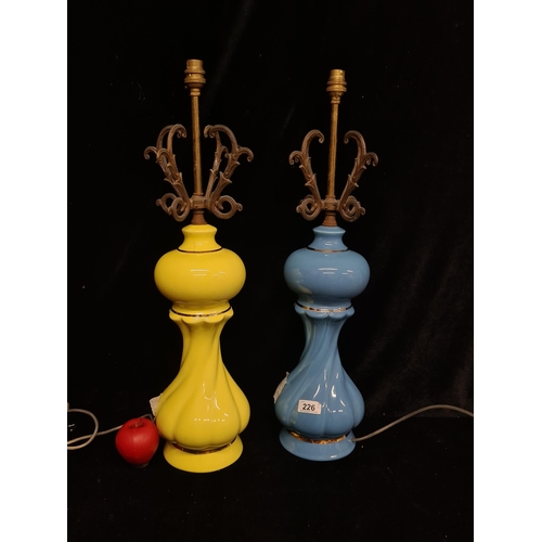 226 - A pair of 1970's retro table lamps with ice cream coloured ceramic bases and brass scrolled tops. Et... 