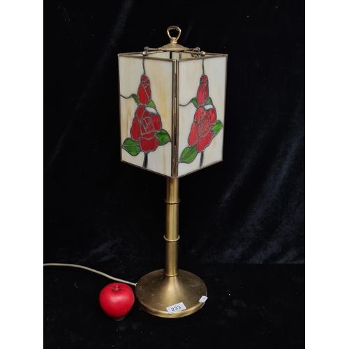 233 - A vintage stained glass table lamp with brass base. Wonderful rose design to shade.