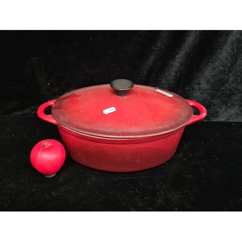 252 - A wonderful heavy cast iron enameled casserole dish. In attractive cherry wine red.