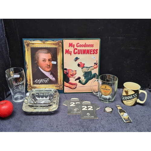 275 - A box containing Guinness Ephemera. Includes Pint glasses, a cup, an ashtray, coasters, keychain and... 