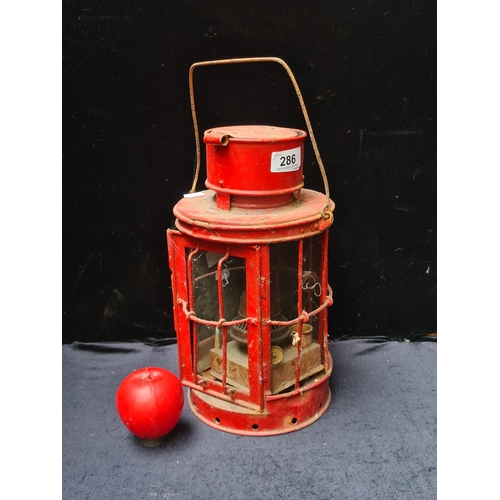 286 - A fabulous antique large red metal railway lantern with two glass panels intact.