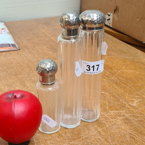 317 - Three EPNS / silver plated topped hat pin  bottles in graduating sizes.