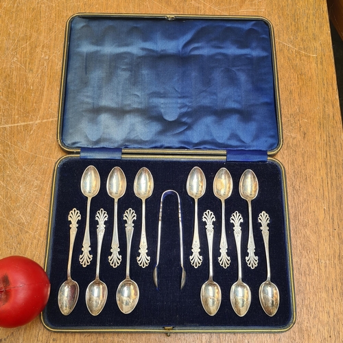 318 - A nicely presented very pretty set of twelve EPNS teaspoons with a pair of sugar tongs. Presented in... 