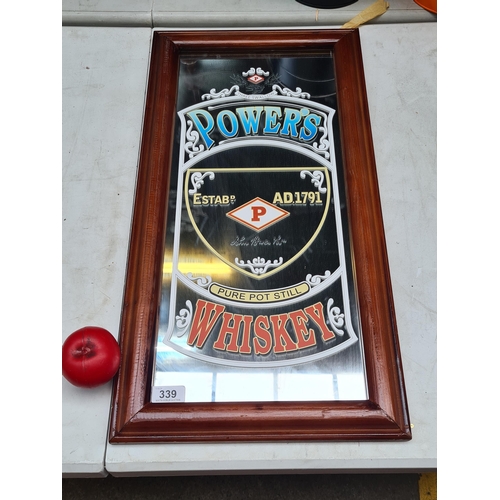 339 - An advertising mirror for Powers Pure Pot Still Whisky. Housed in a wooden frame.