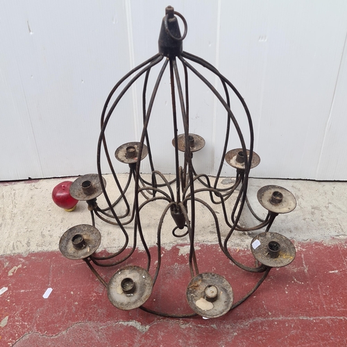 355 - A heavy wrought iron 9 branch hanging candelabra chandelier. Real medieval charm.