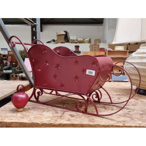 368 - A large  metal Christmas sleigh in a deep red finish. From a top UK interior design company. Not for... 