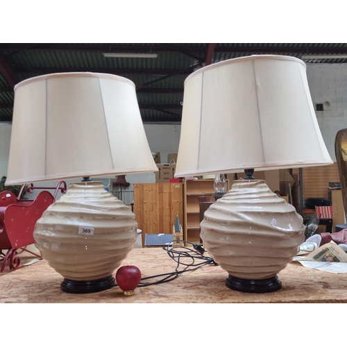 369 - A pair of large Kirkwood Distributors stoneware ceramic table lamps with champagne fabric shade. Lov... 