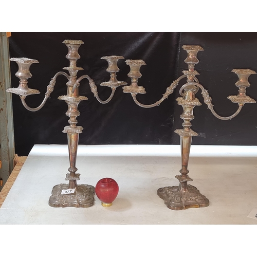 377 - A tall, elaborate pair of heavy silver plate three light candelabras.