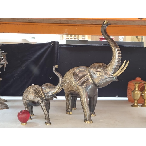 378 - A stunning pair of entirely handcrafted sculptures featuring dancing elephants,  adorned with intric... 