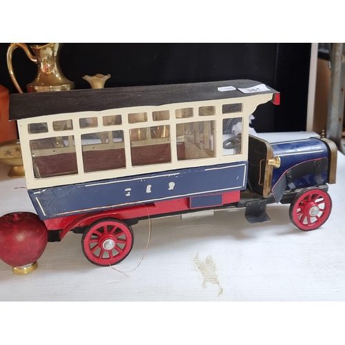 381 - A handsome vintage wooden model bus. This model has a dark roof, white framed windows, a navy blue a... 