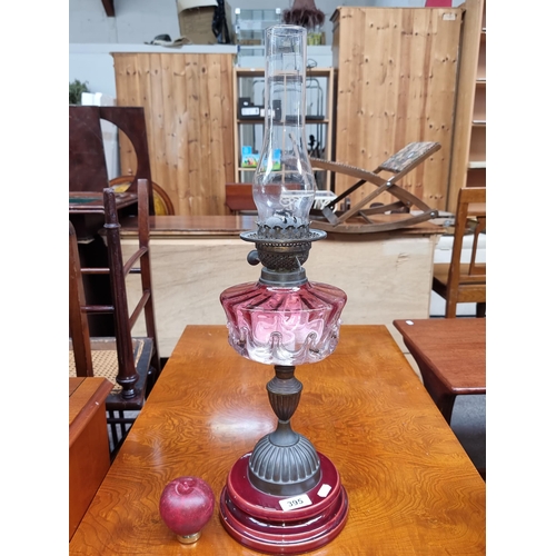 395 - Star Lot : a beautiful antique oil lamp with a ruby glass reservoir and red ceramic base. is beauty.