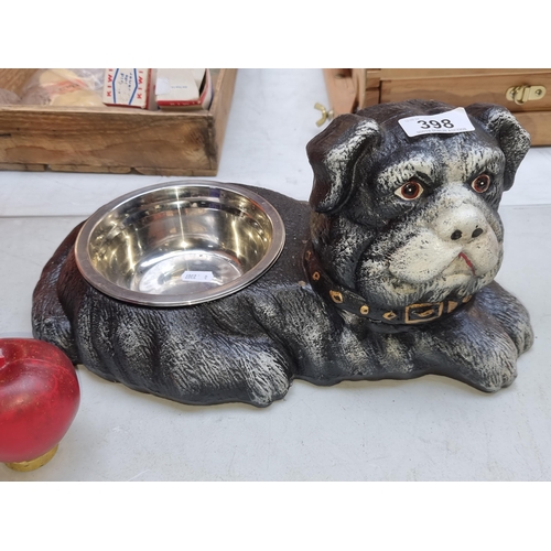 398 - An adorable heavy dog bowl in the form of a lounging dog.