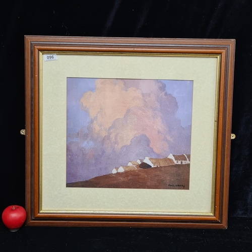 96 - A print of a Paul Henry painting titled 'Cottages on a Hill'. Housed in a wood and gilt frame behind... 