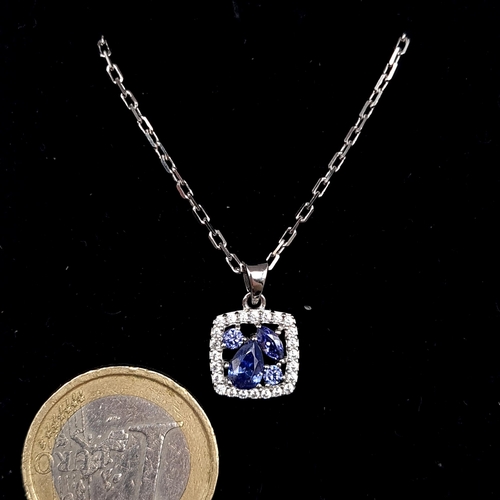 567 - A sterling silver Tanzanite pendant necklace & chain. Length - 46 cms. Set with a gemstone surround.... 