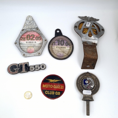 574 - A collection of Motoring memorabilia consisting of tax plates and a AA membership badge, a Royal aut... 