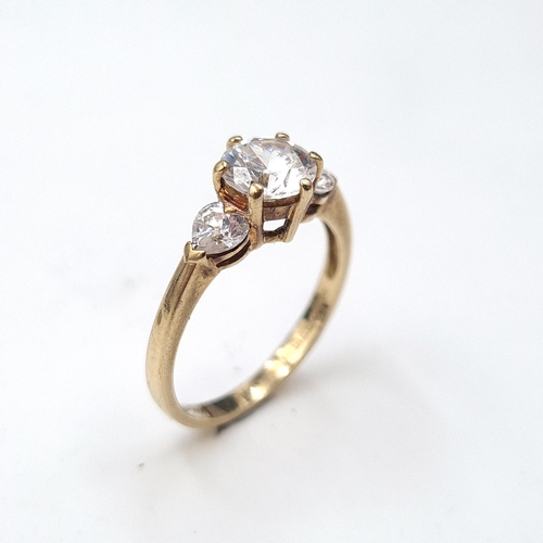 578 - A nine carat gold three stone cubic Zirconia stone ring. Ring size - O. Weight - 2.45 grams. Boxed.