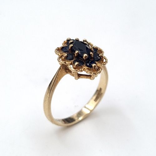 581 - Star Lot : A nice example of a vintage sapphire nine carat gold floral design ring. Size - P. Weight... 