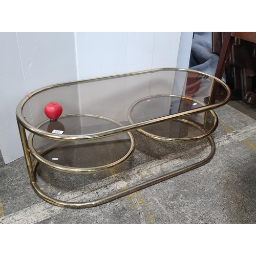 642 - Super Star Lot : A vintage 1960s Italian  signature brass plated oval Sofa table. Features revolving...