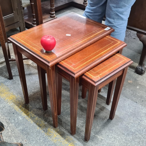 647 - A very handsome nest of three cherry wood tables. Fine quality inlay to top and tapered legs.