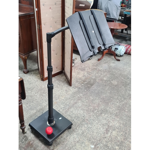 651 - A heavy super quality  fully adjustable music stand / lecture podium. On castors. Can read a large b... 