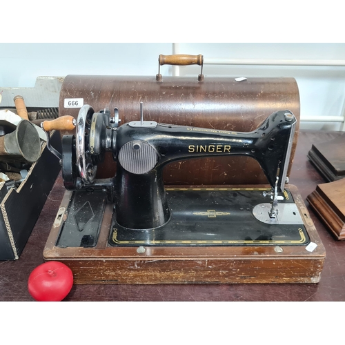 666 - A gorgeous 1950s black and gilt Singer Sewing Machine serial no. EF 745245. Comes with original inst... 