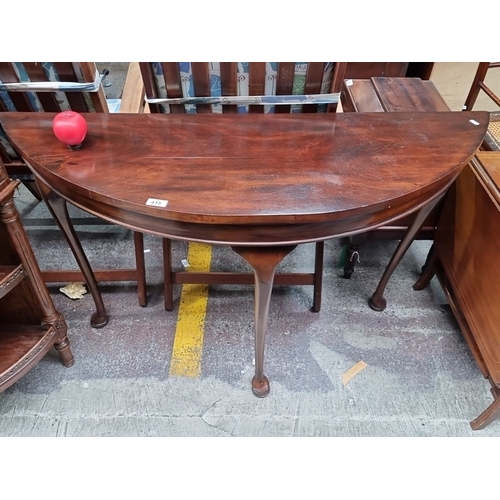 418 - Star Lot : A fabulous Georgian flamed mahogany Demi lune console table with elegant tripod legs. Nic... 