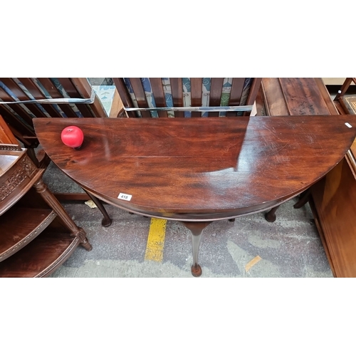 418 - Star Lot : A fabulous Georgian flamed mahogany Demi lune console table with elegant tripod legs. Nic... 