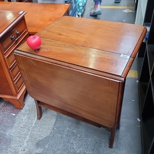 420 - Star lot : A handsome golden mahogany antique  drop-leaf table with inlaid detailing. Features two f... 