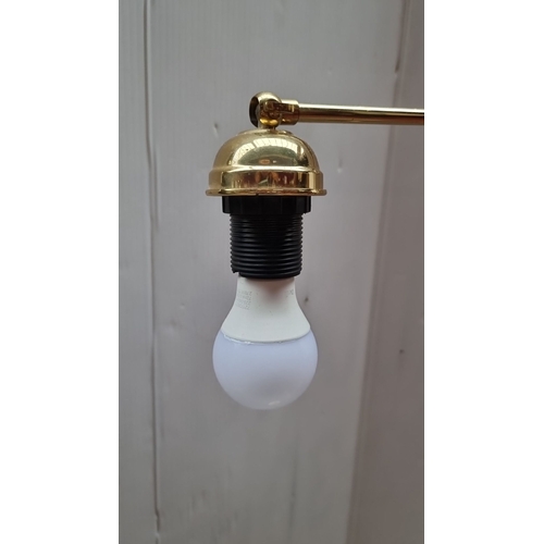 424 - Brass adjustable floor lamp with a single bulb holder and corded switch. It has a simple and elegant... 