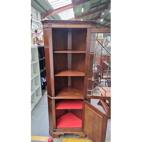 428 - Star Lot : A Mahogany corner cabinet with glazed door and geometric muntins, featuring upper and low... 