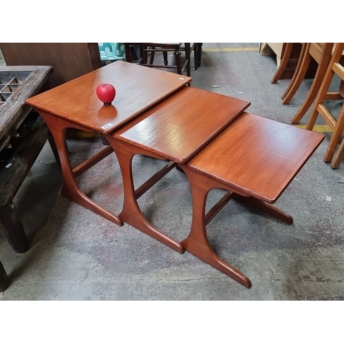 430 - Star Lot : A fabulous set of Mid-Century Modern teak nesting tables with sculpted bases. Includes th... 