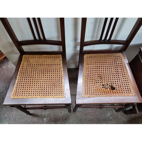 431 - Pair of Victorian mahogany chairs with spindle backs and caned seats, featuring turned legs and cros... 