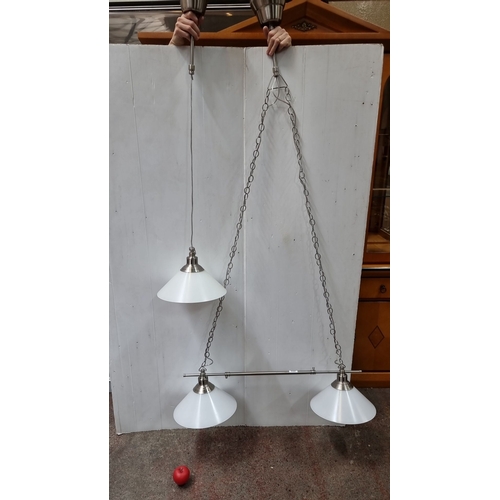 439 - Modern three-light pendant fixture with milk  glass shades and brushed metal finish.